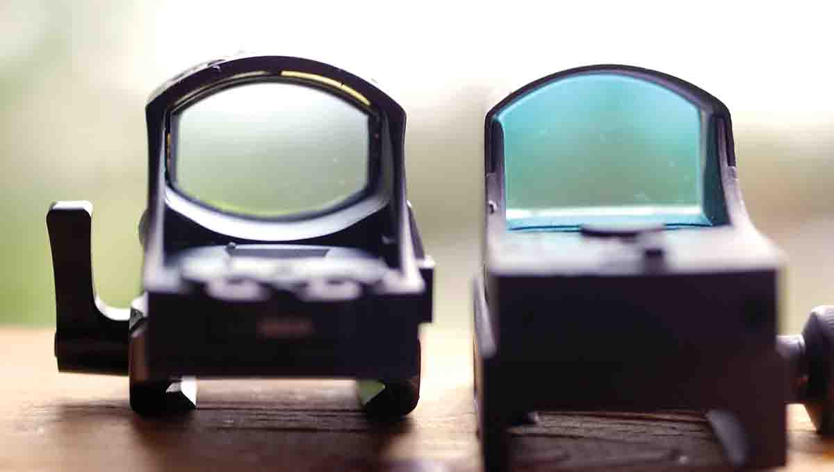 A reflex sight’s objective lens reflects the reticle back toward the shooter’s eye, reducing light coming through the lens. At right is the Sightmark Mini Shot; at left is the Meopta MeoRed.